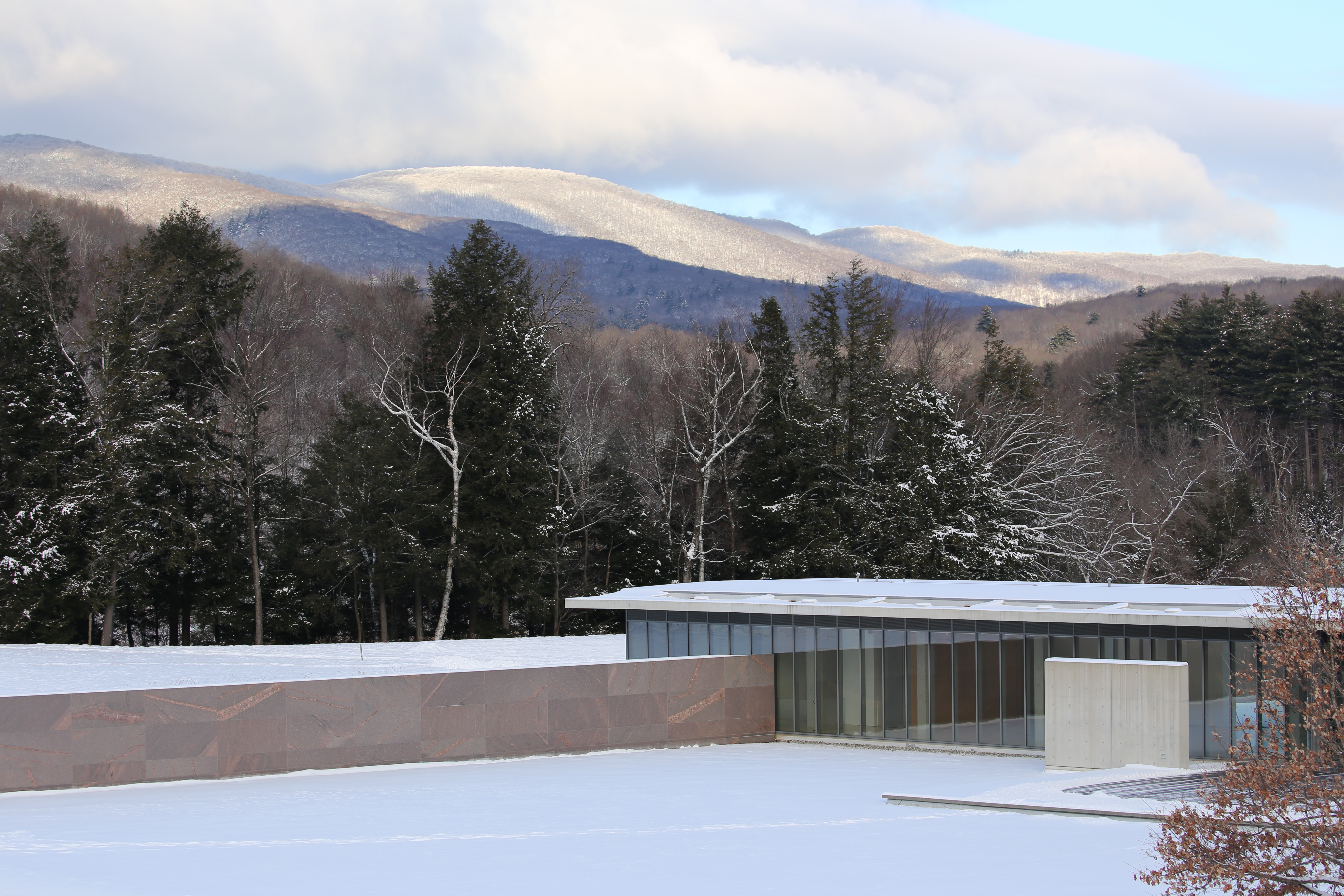 An image of the Clark with snow covered hills behind 